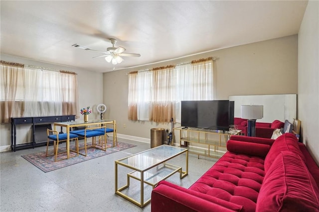 living room with a wealth of natural light and ceiling fan