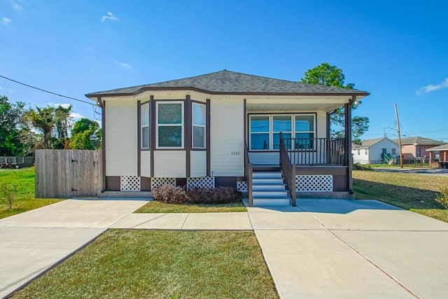 bungalow-style house with covered porch and a front lawn