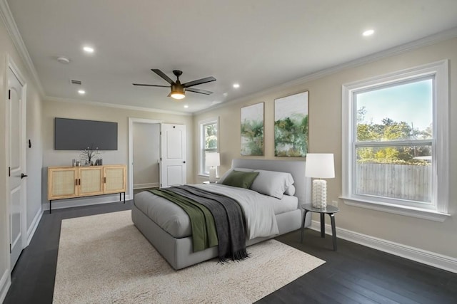 bedroom with crown molding, dark hardwood / wood-style floors, and ceiling fan