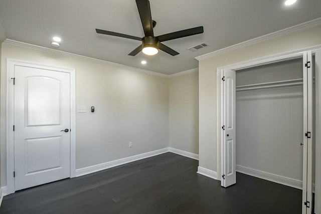 unfurnished bedroom with crown molding, a closet, dark wood-type flooring, and ceiling fan