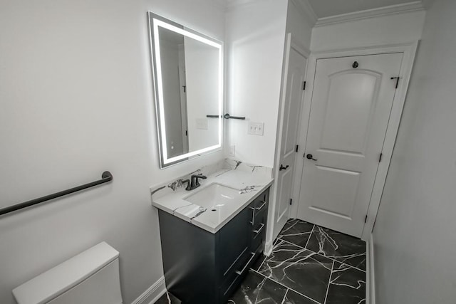 bathroom featuring toilet, crown molding, and vanity