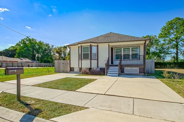 bungalow-style home with a front yard