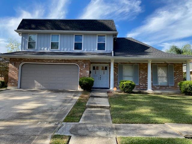 view of front of property with a front yard and a garage