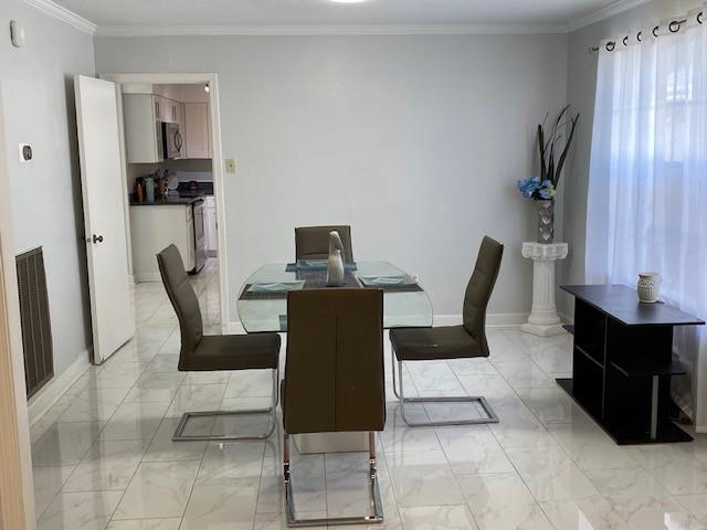 dining room featuring crown molding