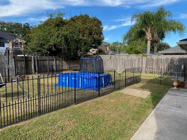 view of pool featuring a yard