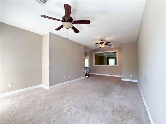 unfurnished living room with light colored carpet and ceiling fan