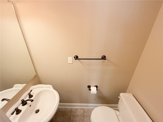 bathroom with tile patterned flooring, toilet, and sink