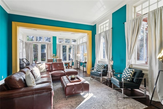 living area featuring wood-type flooring and crown molding