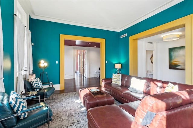 living room featuring hardwood / wood-style flooring and crown molding