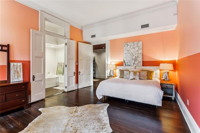 bedroom with ensuite bathroom, dark hardwood / wood-style flooring, and ornamental molding