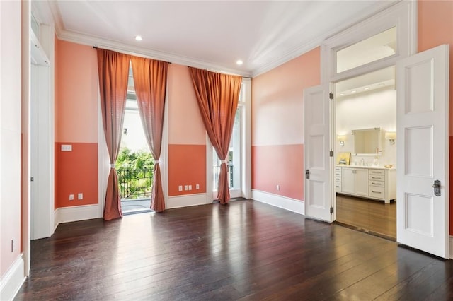 spare room with dark hardwood / wood-style floors, sink, and ornamental molding