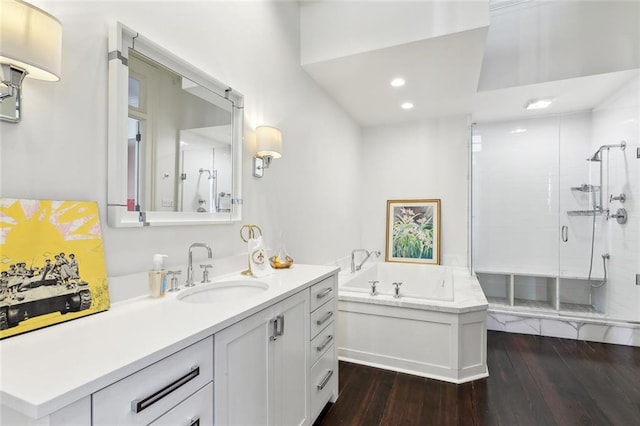 bathroom featuring independent shower and bath, vanity, and hardwood / wood-style flooring