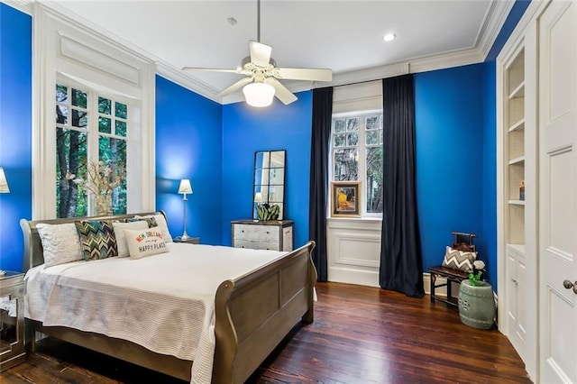 bedroom with ceiling fan, dark hardwood / wood-style floors, and crown molding