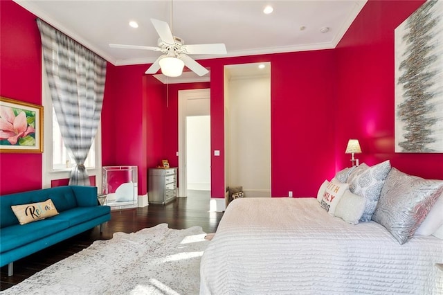 bedroom with ceiling fan, dark hardwood / wood-style floors, and ornamental molding