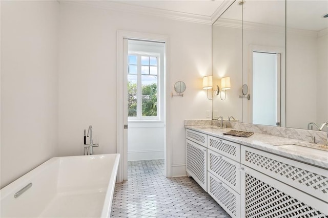 bathroom with ornamental molding, tile patterned flooring, a washtub, and vanity