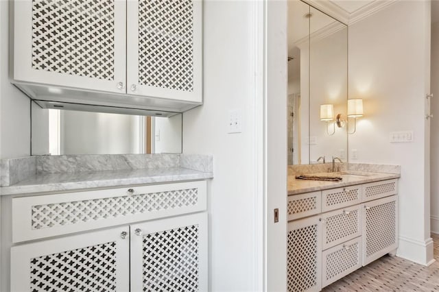 interior space featuring vanity and ornamental molding