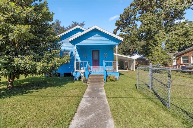 bungalow-style home featuring a front yard, a carport, and a porch