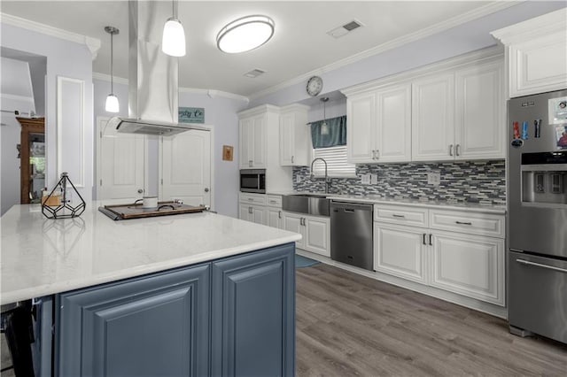 kitchen with appliances with stainless steel finishes, sink, decorative light fixtures, white cabinets, and extractor fan