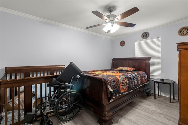 bedroom with ceiling fan, crown molding, and light hardwood / wood-style floors