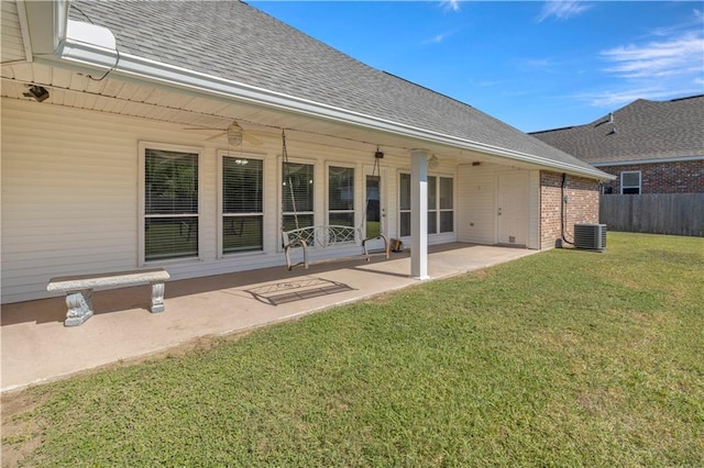 rear view of property featuring a patio area and a lawn