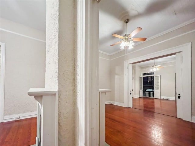 hallway with ornamental molding and hardwood / wood-style floors