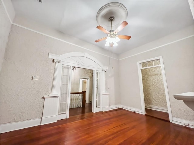 empty room featuring ceiling fan and dark hardwood / wood-style flooring