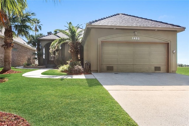 view of front of home with a garage and a front yard