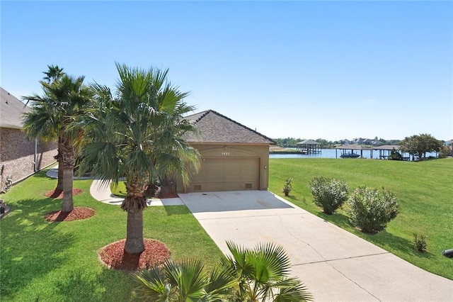 view of front of house with a garage, a water view, and a front yard