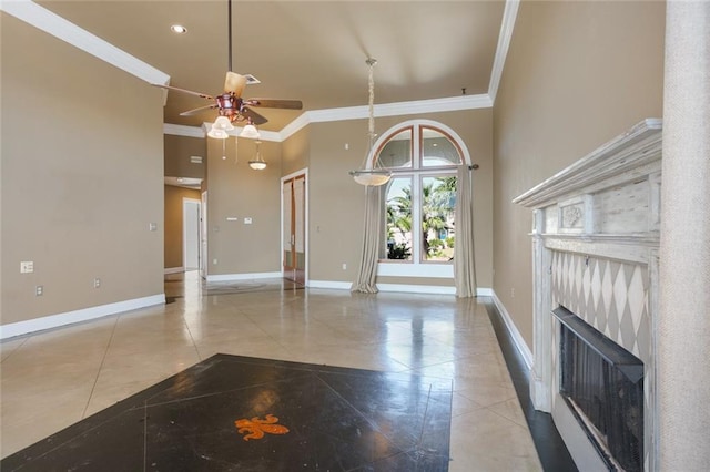 unfurnished living room featuring a towering ceiling, light tile patterned floors, ceiling fan, and crown molding