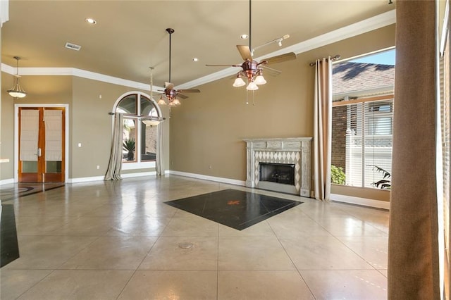 unfurnished living room with light tile patterned floors, ceiling fan, and crown molding