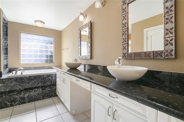 bathroom with vanity, tiled bath, and tile patterned floors