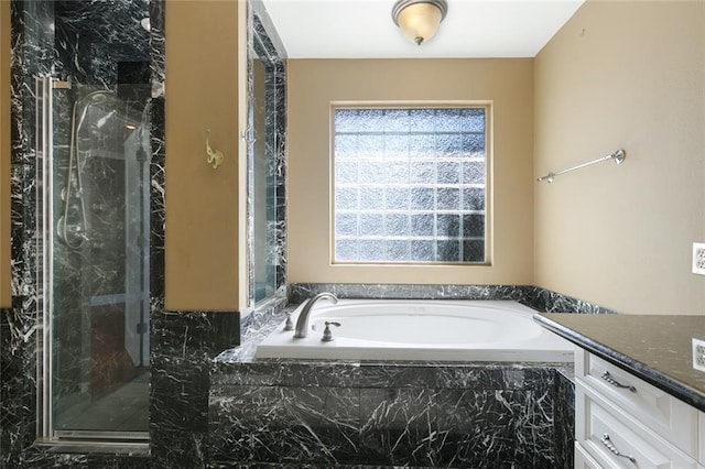 bathroom with vanity and separate shower and tub