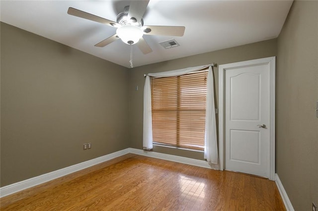 empty room with light wood-type flooring and ceiling fan