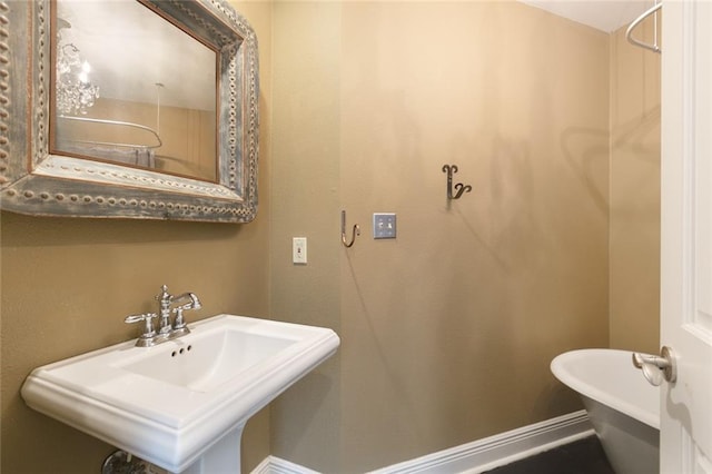 bathroom featuring a washtub and sink