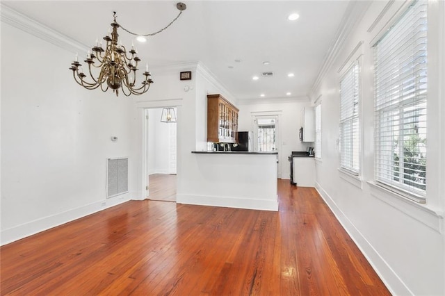 kitchen with hardwood / wood-style floors and crown molding