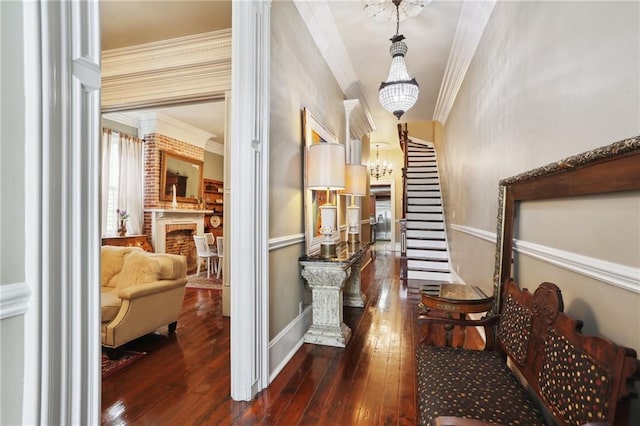 interior space featuring crown molding, a brick fireplace, and dark hardwood / wood-style floors