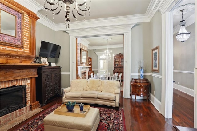 1214 Felicity St, New Orleans, LA 70130 - living area featuring a chandelier, wood-type flooring, a brick fireplace, crown molding, and baseboards