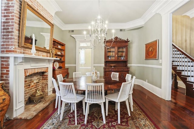 dining room with a notable chandelier, ornamental molding, a fireplace, and hardwood / wood-style floors