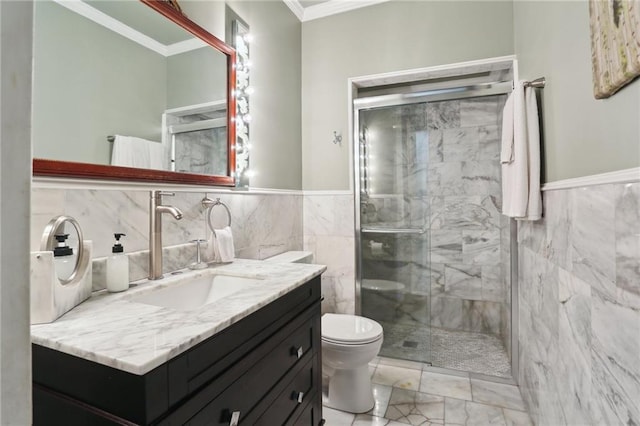 bathroom featuring toilet, a shower with shower door, vanity, crown molding, and tile walls