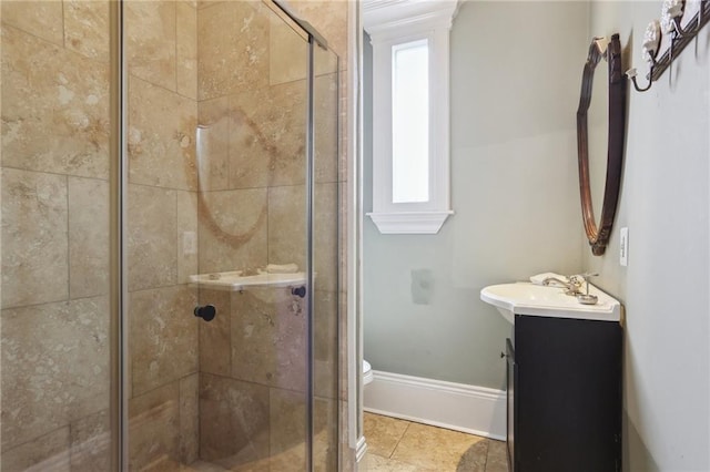 bathroom featuring vanity, an enclosed shower, and toilet