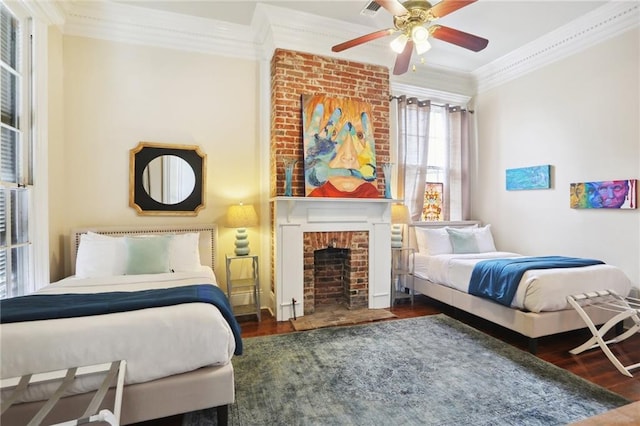 bedroom featuring ceiling fan, crown molding, a brick fireplace, and dark hardwood / wood-style floors