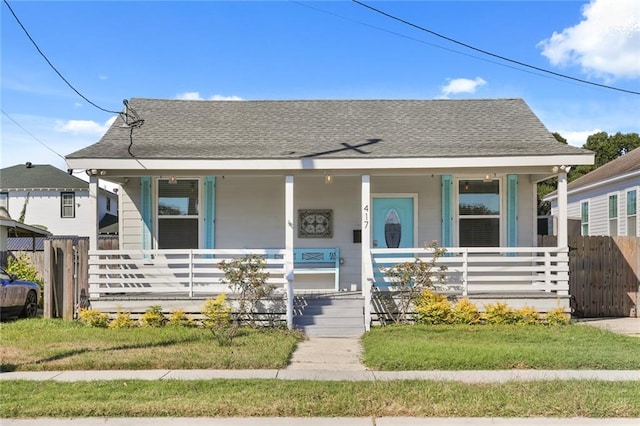 bungalow-style house with covered porch and a front lawn