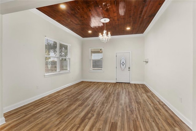 interior space featuring a chandelier, crown molding, wood-type flooring, and wooden ceiling