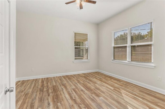 spare room with light hardwood / wood-style floors and ceiling fan