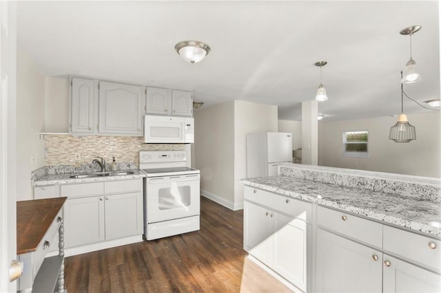 kitchen with hanging light fixtures, white cabinetry, dark hardwood / wood-style floors, sink, and white appliances