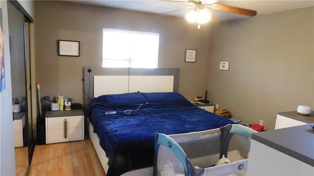 bedroom featuring light hardwood / wood-style floors and ceiling fan