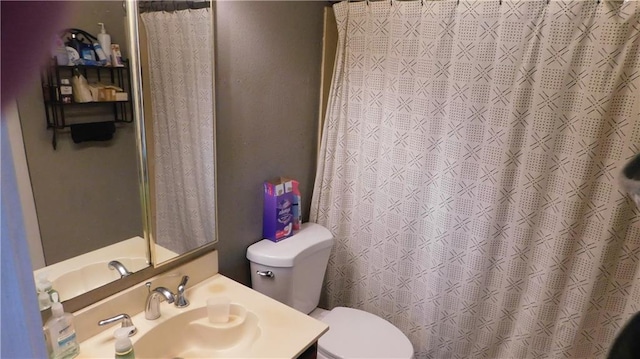 bathroom featuring vanity, toilet, and walk in shower