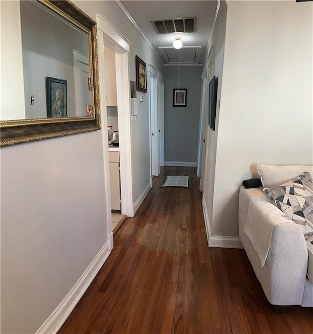 hall featuring ornamental molding and dark hardwood / wood-style flooring