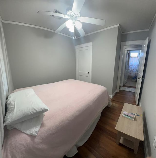 bedroom with baseboards, ornamental molding, a ceiling fan, and dark wood-type flooring
