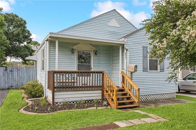 bungalow-style house featuring a porch and a front lawn